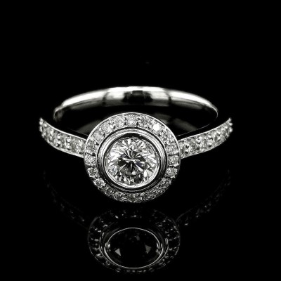 0.49 CT. CENTRAL DIAMOND RING WITH HALO AND ACCENTS