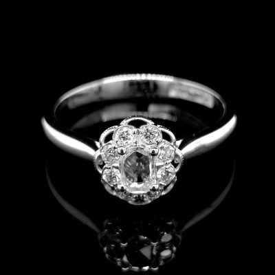 ROSETTA RING WITH 0.15 CT. CENTRAL OVAL DIAMOND